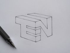 a pen is laying on top of a piece of paper with the letter e in it