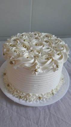 there is a white cake with flowers on the top and bottom layer, sitting on a table