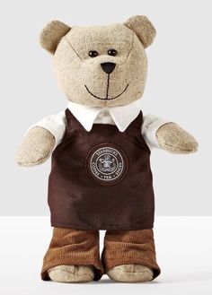 a teddy bear wearing a brown vest and white shirt