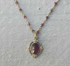 This vintage-inspired necklace is handmade using a 2mm genuine garnet wire-wrapped chain and a 12x17mm pendant with an authentic 6x8mm garnet stone.  This necklace is hypoallergenic. (Cadium free, lead free, and nickel safe) Garnet is an energizing stone that promotes passion and love.  The necklace comes in a hand-wrapped gift box, ready to be gifted. If you would like to leave a note for the recipient, you can do so during checkout. Please note that each stone is unique and varies in color. Garnet Necklace Vintage, Vintage Necklace Aesthetic, Unique Jewelry Vintage, Vintage Inspired Jewelry, 1 Tattoo, Antique Gold Jewelry, Inspired Necklace, Garnet Necklace, Dope Jewelry