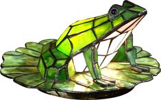 A handsome prince in disguise, the frog in the fanciful Odette Grove lamp is so life like he appears to be ready to leap off his lily pad and into a pond. Art glass in various shades of green, white and yellow make up this three dimensional frog sitting on a glass lily pad base. Whether you are a princess at heart or just looking to add a whimsical touch to your home, this delightful little accent lamp is for you. Partial assembly may be required. Stained Glass Frog, Frog Lily Pad, Tiffany Art, Glass Frog, Arte Inspo, Tiffany Lamps, Antique Lamps, Tiffany Style, Accent Lamp