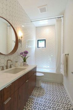 a bathroom with a sink, toilet and bathtub next to a shower curtained window