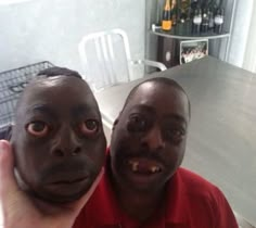 two men with their faces painted like they are holding something up in front of them