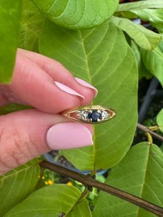 14k Vintage Sapphire & Diamond Ring Description: This 14k vintage ring features a stunning blue sapphire center stone accented by natural diamonds on either side. Currently sized at 5 3/4, it is resizable upon request. This dainty ring is perfect for stacking and adds a touch of elegance to any jewelry collection. Weighing 1.46 grams, it's a lightweight yet durable piece that can be worn daily or on special occasions. This piece, like all our jewelry, is a rare find—once it's gone, it's gone. Ch Vintage Blue Sapphire Ring With Diamond Accents, Heirloom 14k Gold Sapphire Ring With Single Cut Diamonds, Vintage Sapphire Three Stone Diamond Ring, Vintage Blue Diamond Ring With Single Cut Diamonds, Vintage Diamond Ring With Sapphire And Diamond Accents, Sapphire Ring With Diamond Accents And Marquise Cut, Vintage Blue Ring With Single Cut Diamonds, Vintage Sapphire Three Stone Ring, Vintage Sapphire Three-stone Ring