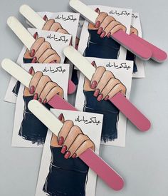 four popsicles with pictures of women's hands and nails on them in arabic writing