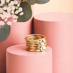 Looking for a unique and special gift? Or maybe you're just treating yourself? Either way, our Initial Stacking Rings Set of 7 in Gold, Silver, or Rose Gold is sure to fit the bill! Personalize these gorgeous rings with any uppercase letter in an arial-style font, making them perfect for representing yourself or your loved ones. The set comes with two initial rings and five heavy weight "Raw Silk" stackers, all in your choice of Sterling Silver, 14K Yellow Gold Fill, or 14K Rose Gold Fill. Stack Personalized Fine Jewelry Yellow Gold Rings, Personalized Yellow Gold Rings In Fine Jewelry Style, Stackable Round Jewelry For Anniversary, Stackable Initial Ring With Round Band In Fine Jewelry, Fine Jewelry Stackable Initial Ring With Round Band, Stackable Yellow Gold Midi Rings For Anniversary, 14k Gold Stackable Jewelry For Anniversary, Yellow Gold Stackable Midi Rings Anniversary, Heirloom Stackable Jewelry As Gift