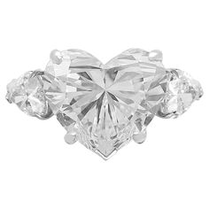 a heart shaped diamond ring with three stones