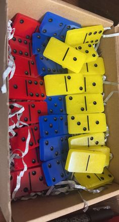 a box filled with lots of different colored dominos