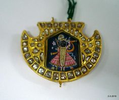 20kt Vintage Antique tribal gold jewelry pendant necklace from Rajasthan India. great handmade design good for jewelry collection.Subject of this pendant is Hindu God Shreenath Ji (krishana).Note - Pendant is filled with wax. Please check pictures carefully for more detail.weight approx - 11 gramssize - 3.4/4.4 cmmaterial - 20k yellow gold, kundan polky, wax inside. 22k Gold Temple Necklace Pendant For Festivals, 22k Gold Kundan Pendant Necklace For Diwali, Kundan Pendant Temple Necklace As Gift, Kundan Temple Necklace With Pendant For Gift, Meenakari Pendant Temple Necklace For Puja, Meenakari Temple Necklace Pendant For Puja, Festival Meenakari Temple Necklace Pendant, 22k Gold Pendant Temple Necklace For Festivals, Navratri Meenakari Temple Necklace In 22k Gold