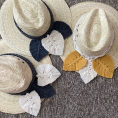 three hats are laid out on the floor