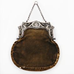 A Victorian Chatelaine Purse With A 900 Silver Frame. The Silver Frame Is Modeled With Reticulated Laurel Swag, Floral Accents And A Lyre To The Center. The Body Of The Bag Is Green Velvet With One Divided Pouch To The Interior. Dimensions 7.25" W X 7.5" H X 0.75" D Luxury Silver Evening Bag With Detachable Handle, Luxury Formal Shoulder Bag With Silver Accents, Luxury Shoulder Bag With Silver Accents For Formal Occasions, Designer Silver Evening Bag With Detachable Handle, Designer Silver Bags With Silver Accents, Rectangular Wedding Bags With Silver-tone Hardware, Designer Evening Bags With Silver Accents, Elegant Engraved Shoulder Bag, Elegant Formal Shoulder Bag With Silver Accents