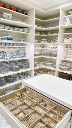 the shelves are filled with plates and other decorative items in blue and white dishes on them