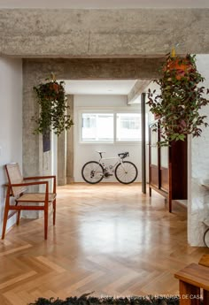 an empty room with two chairs and a bicycle on the wall next to each other