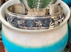 Berra Tawahongva is a well acclaimed Hopi jeweler known for his sterling silver overlay work which is sought by collectors. This intricately designed sterling silver cuff has symbols of corn, rain, sun, with kokopelli and a Koyemsi Mudhead Katsina, a hand, and other symbolic Hopi designs.  In the 1980s Towahonga worked at the Hopi Guild Shop which is where he mastered his craft. He draws his inspiration from ancient petroglyphs and the ceremonies at Hopi.  The overlay method is when a top layer Philip Sekaquaptewa Hopi Jewelry, Tucson Az, Sterling Silver Cuff, Silver Cuff, A Well, Tucson, The 1980s, Indian Jewelry, Cuff Bracelet