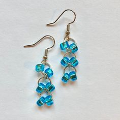 the earrings are made with blue glass beads