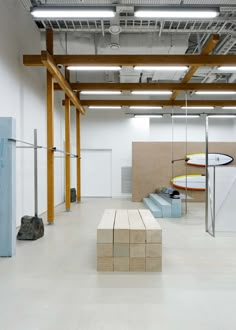 an empty room with benches and surfboards in it