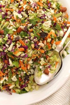 a salad with carrots, celery, and nuts in a white bowl