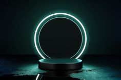 an illuminated circular object sitting on top of a black surface in the middle of a dark room