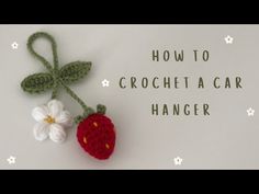 a crochet strawberry hanging on a wall with the words how to crochet a car hanger