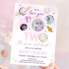 a pink and gold space themed birthday party card with stars, planets, and saturn on it