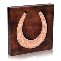 a wooden box with a horseshoe shaped like a horse shoe on it's side