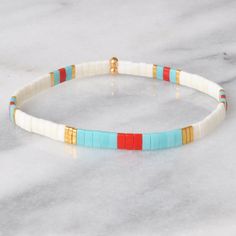 Like little works of art you can wear, these stretch tile bracelets — all in exclusive Libby & Smee patterns — are perfect on their own or in one of our curated sets. Stacking is strongly encouraged. style: PHOENIX glass tile beads in matte ivory, matte red, and turquoise, and gold stretch cords finished with gold-plated crimp covers, lead-free and nickel-free comes in one 7" size to fit most wrists, perfect for stacking with other bracelets packaged in a clear resealing bag for storage and gift giving Pick any three three tile bracelets and save $20: Libby & Smee Tile Bracelet Sets to keep your jewelry looking new, avoid water, lotions and perfumes never swim or shower in your Libby & Smee jewelry Tile Bracelets, Tile Bracelet, Lotions And Perfumes, Bracelet Packaging, Red And Turquoise, Bracelet Sets, Turquoise And Gold, Matte Red, Glass Tile