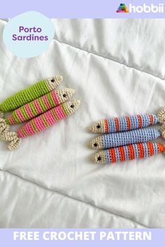 three crocheted animals laying on top of a white bed next to each other