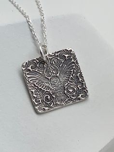 This small minimalist modern floral owl necklace has been entirely handmade using .999 fine silver. It has been cut out from fine silver precious metal clay, textured, fired and oxidized. The pendant hangs from a sterling silver diamond cut cable chain. This fine silver pendant features an embossed textured floral owl pattern. Pendant size: approximately 5/8 x 5/8 inches Chain length: adjustable at 16 and 18 inches can also be customized to whatever length needed The necklace is sent in a gift b Owl Necklace Silver, Owl Pattern, Precious Metal Clay, Owl Necklace, Flower Jewelry, Layering Necklace, Metal Clay, Pendant Silver, Precious Metal