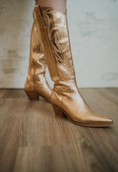 Western-inspired knee high boot with a sophisticated silhouette. Details: Leather upper Manmade outsole 15 in / 38.1 cm shaft height 14 in / 35.56 cm boot opening 2.5 in / 6.35 cm heel Textile lining Padded insole Pull on style Gold color Fits true to size Gold Boots, Color Fits, Cowboy Boots Women, Bags And Shoes, Boots Women, Knee High Boots, Cowboy Boots, Knee High, Gold Color