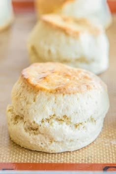 three biscuits sitting on top of a cookie sheet