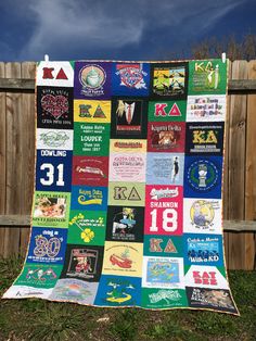 a quilt is hanging on a fence with many different patches and numbers all over it