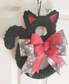 a minnie mouse wreath hanging on the front door