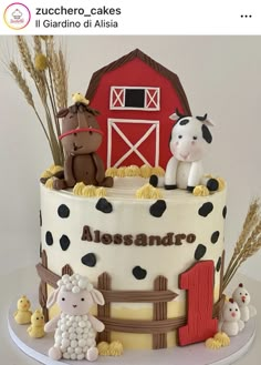 a cake decorated with farm animals and a barn