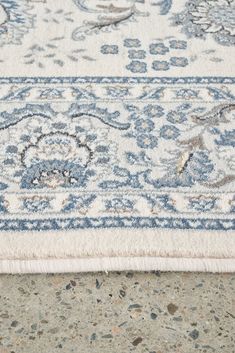 an area rug with blue and white designs on the top is shown in close up