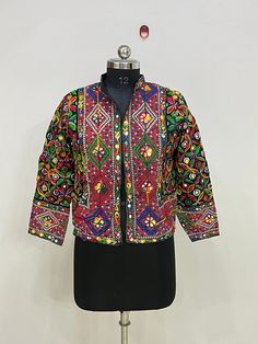 Indian Vintage Mirror Work Jacket Women Handmade Embroidery Mirror Work Festival Fashion Wear Jacket, Vintage Banjara Overcoat Jacket Handmade Women Cotton Designer Jacket, This Jacket Is Made By Hand And Embroidered By Local Artisans, This Jacket Have No Closer  Long Sleeves And Vibrant Colors, Must Add In Your Wardrobe Product Detail Material :- Cotton Embroidered Length :- 21 inch Sleeve Length :- 20 Inch NOTE : Product color may slightly vary due to photographic lighting sources or your moni Traditional Festival Outerwear With Mirror Work, Traditional Long Sleeve Outerwear With Mirror Work, Festive Outerwear With Multicolor Embroidery And Motifs, Festive Multicolor Intricately Embroidered Outerwear, Traditional Multicolor Outerwear For Festivals, Traditional Winter Outerwear With Mirror Work, Multicolor Motif Outerwear For Festivals, Multicolor Embroidered Outerwear For Festivals, Long Sleeve Multicolor Outerwear With Handwork