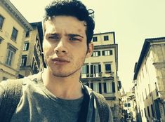 a man standing in front of some buildings