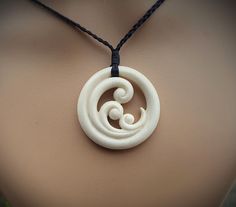 a white necklace with an intricate design on it