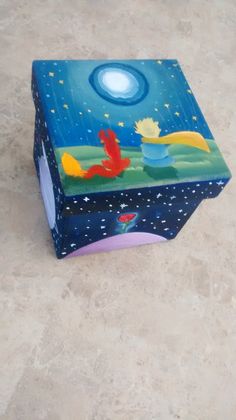 a painted box sitting on top of a floor