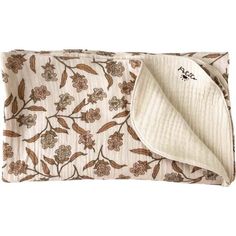 a white and brown flowered blanket with a pocket on it