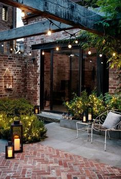 an outdoor patio with brick walls and lights