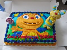 a birthday cake with an image of a cartoon character on the front and back side