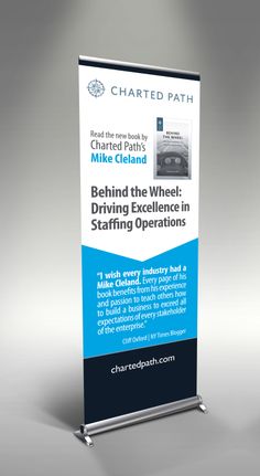 a roll up banner with the words behind the wheel driving excellence in staffing operations