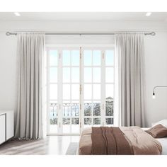 a bedroom with white walls and wooden floors