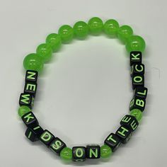 Glow in the dark acrylic beaded bracelet . BH LOVE bracelet that celebrates the nostalgia of The magic Summer Tour in fun glow in dark neon colors.  ️ best fits 6 1/2"-7 1/4"  wrists Green Fun Plastic Jewelry, Fun Green Plastic Jewelry, Green Themed Beaded Bracelets, Adjustable Green Fun Jewelry, Green Novelty Jewelry For Birthday, Fun Green Bracelets For Friendship, Novelty Green Beaded Bracelets For Friendship, Green Letter Beads Jewelry For Birthday, Fun Green Stretch Bracelet With Letter Beads