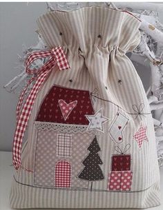 a bag that is sitting on top of a white tablecloth covered tree with red and white checkered ribbon