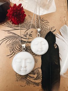 This enchanting Bone Pearl Moon Face necklace, set in sterling silver, captures the magic of the moon in a beautifully carved design. Available in two sizes, the moon face pendant radiates an ethereal charm, making it both a unique statement piece and a symbol of intuition and mystery. The bone pearl adds a natural, organic feel, while the sterling silver setting enhances its timeless elegance. Hanging from an 18" sterling silver ball chain, this necklace blends artistry and elegance, perfect for those who are drawn to the moon's quiet power. Ready to ship, it's a stunning piece for everyday wear or special occasions. Anniversary Gifts Ideas, Face Carving, Face Pendant, Face Necklace, White Moon, Moon Face, Moon Ring, Charm Making, Peridot Gemstone