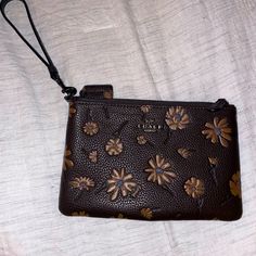 Coach Floral Wristlet, Never Used Brown Clutch Pouch With Wrist Strap, Brown Pouch Wristlet For Travel, Brown Pouch With Wrist Strap For Daily Use, Coach Leather Pouch Clutch, Brown Clutch Wristlet For Travel, Brown Clutch Wristlet For Everyday Use, Brown Wristlet With Removable Pouch As Gift, Brown Clutch Wristlet, Brown Everyday Clutch Wristlet