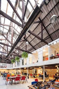 the inside of a building with tables and chairs