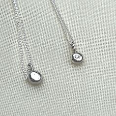 Set on a diamond cut curb chain this petite pendant is made from sterling silver casting grain and is the perfect stacking piece to add to your collection. It is an everyday classic, the diamond creates an elegant look with any outfit. Minimalist Sterling Silver Diamond Necklace With Polished Finish, Minimalist Sterling Silver Necklace With Polished Finish, Silver Sterling Solitaire Necklace With Round Pendant, Silver Diamond Pendant Necklace For Everyday, Everyday White Gold Sterling Silver Diamond Necklace, Silver Sterling Initial Pendant Diamond Necklace, Silver Engraved Diamond Pendant Necklace, Engraved Silver Diamond Pendant Necklace, Silver Diamond Pendant Necklace Engraved