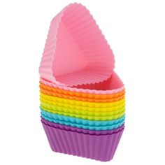 a cupcake pan filled with rainbow colored baking cups